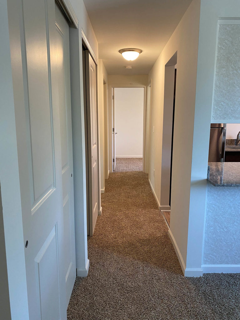 Hallway view with plush carpeting