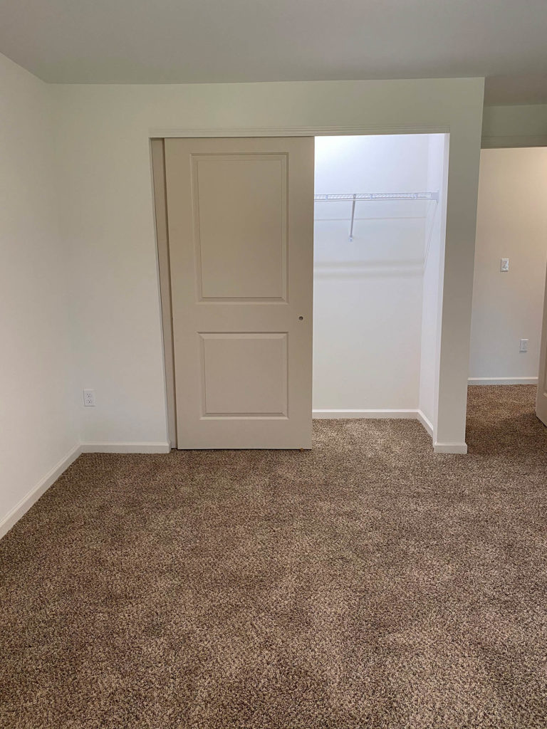 Renovated bedroom with plush carpeting