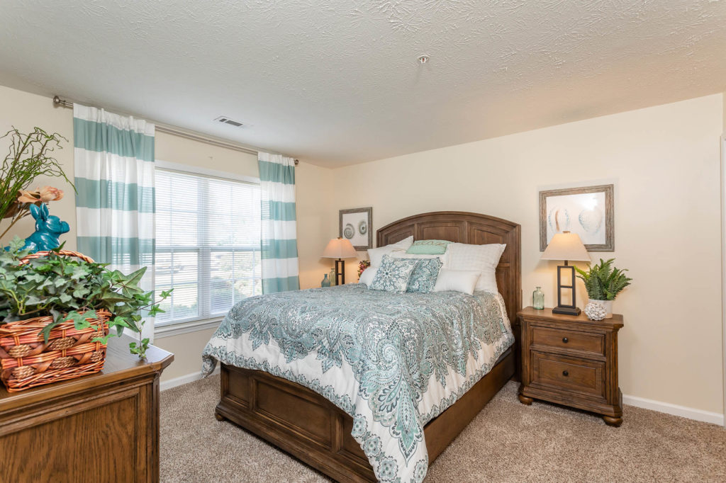 Inviting Master Bedroom featuring plush carpeting and ample windows for abundant natural lighting, creating a cozy and well-lit retreat.