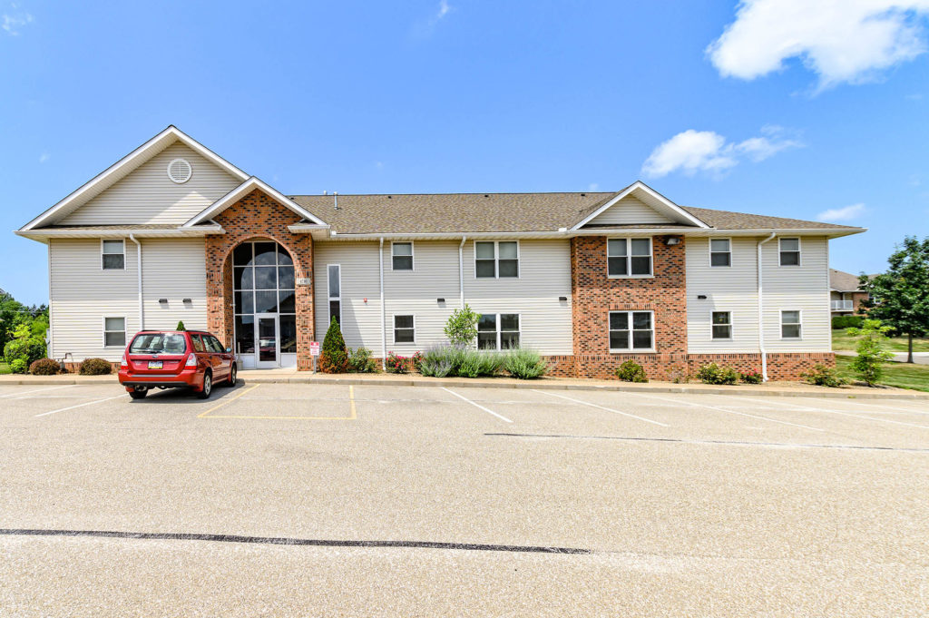 An image of a Laurel Springs Apartment building with a charming combination of siding and brick, providing a welcoming and aesthetically pleasing structure for residents.
