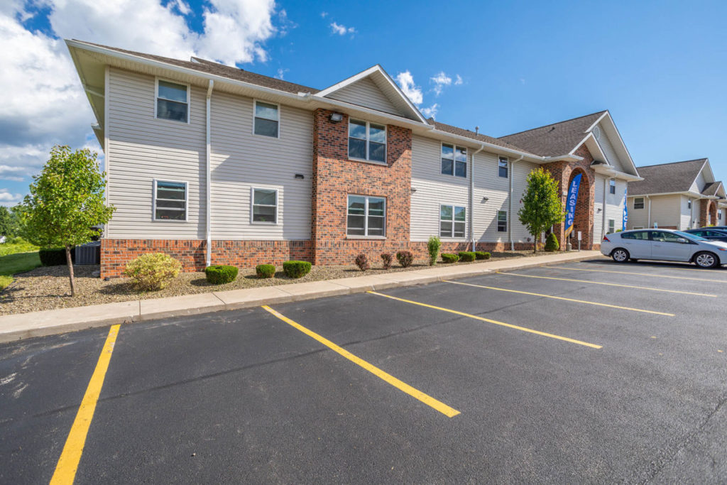 An exterior image of the leasing office at Laurel Springs Apartments, conveniently situated with ample parking, including a designated handicapped section.
