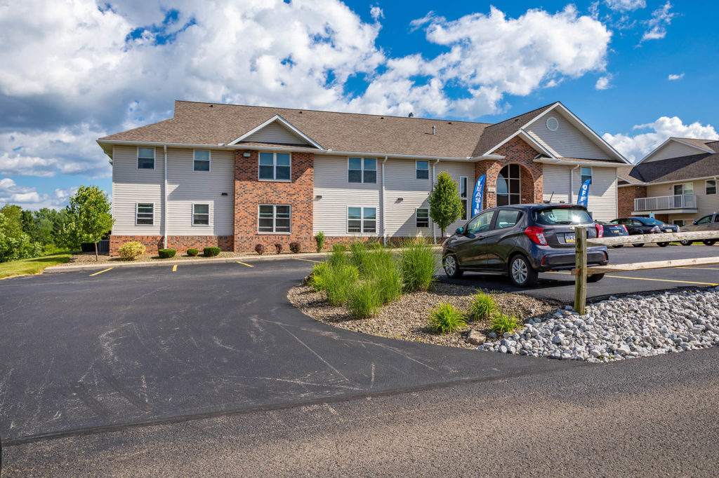An exterior image of the leasing office at Laurel Springs Apartments, conveniently situated with ample parking, including a designated handicapped section.