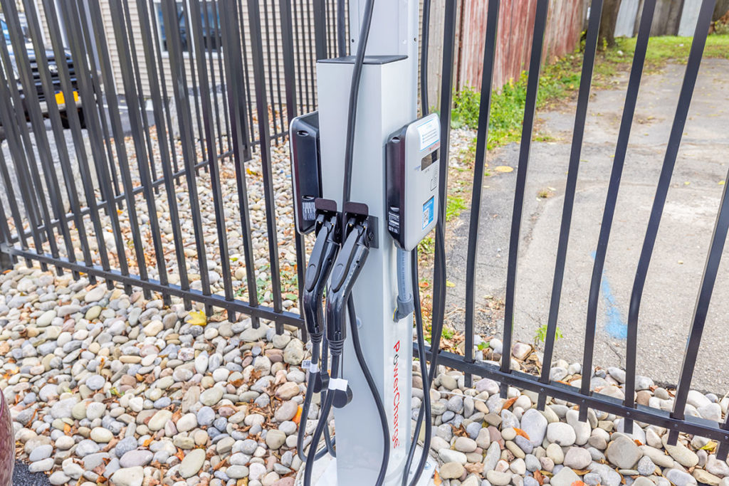Electric car charging station located outside in the parking lot of Six67 College Avenue