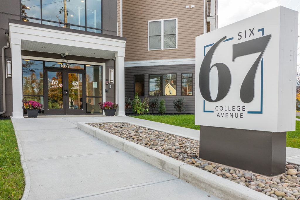 Front entrance and community sign for Six67 College Avenue Apartments in Elmira NY