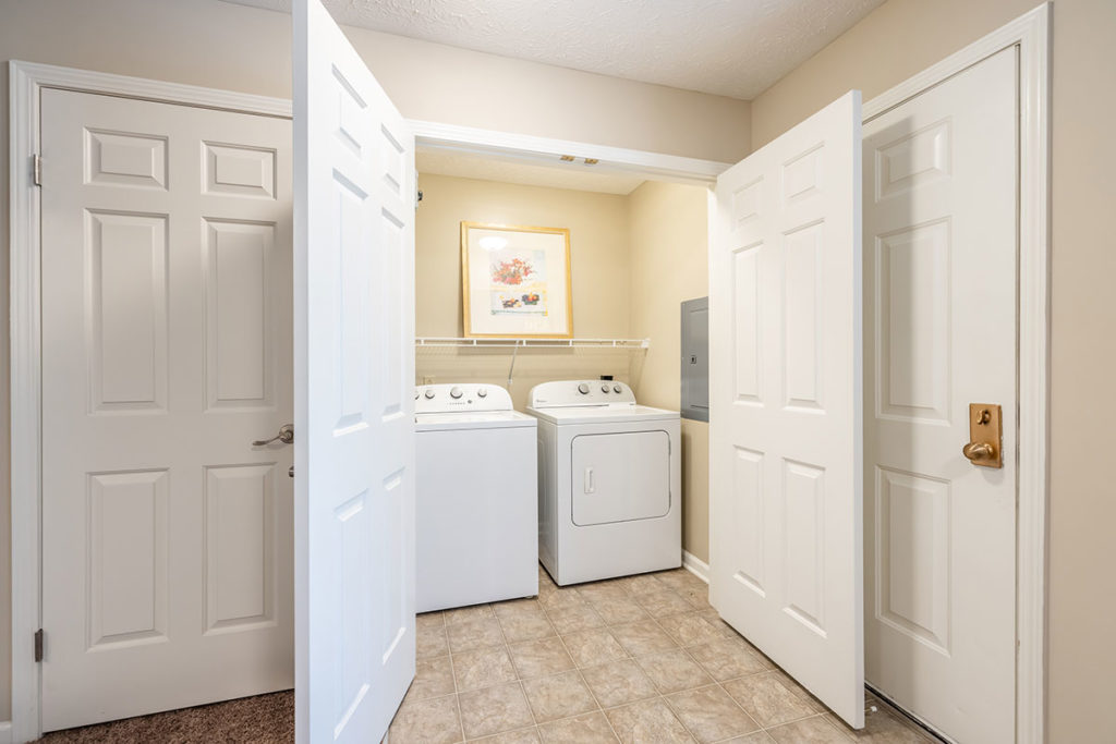 In-home Full-size Washer & Dryer room with shelving | The Hammocks at Southern Hills