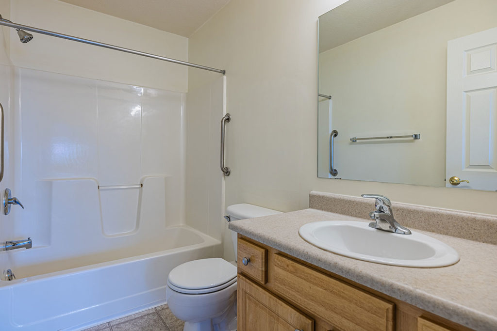 Bathroom with shower/tub and ceramic tile flooring and single vanity.