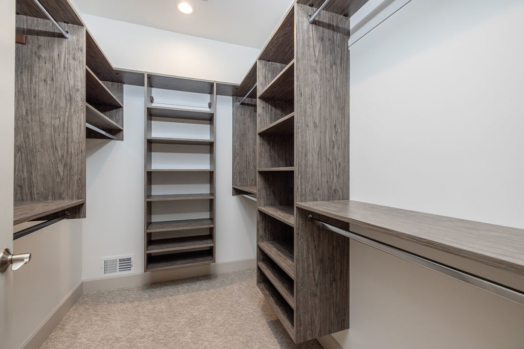 Master bedroom walk-in closet with built in closet organizer.