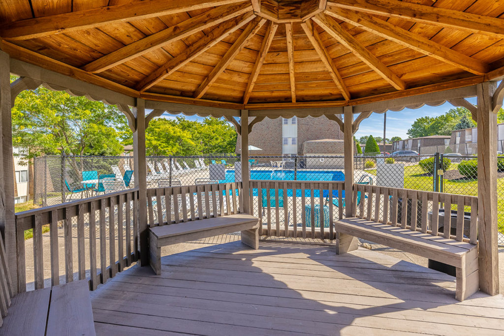 Large community gazebo with plenty of seating located near the swimming pool