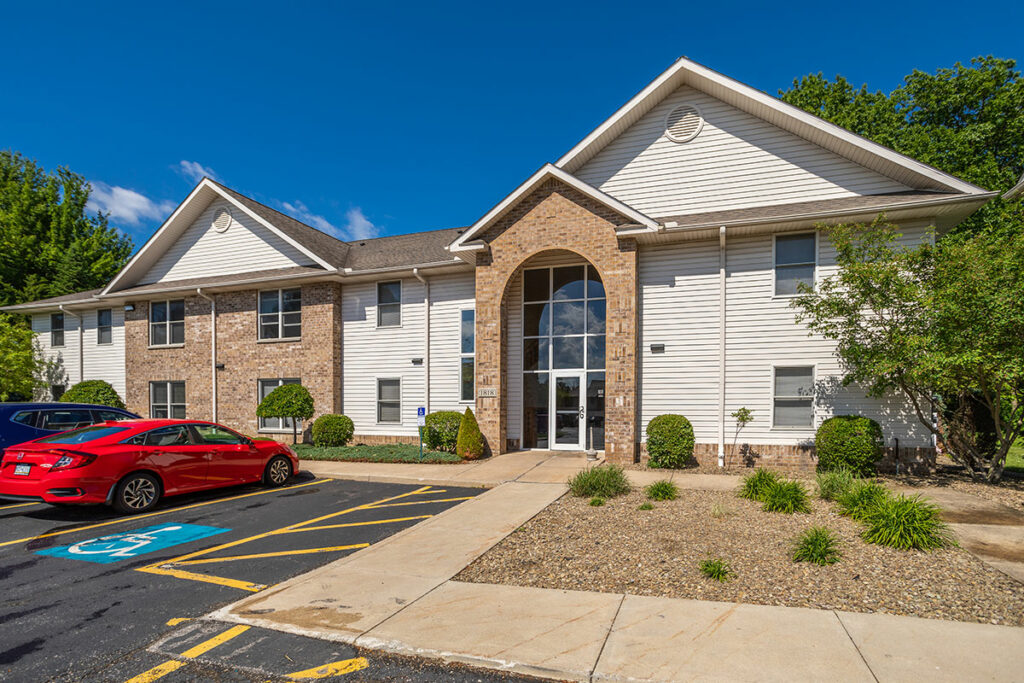 Entrance to Laurel Ridge apartment building with handicap accessible parking as well as additional parking.