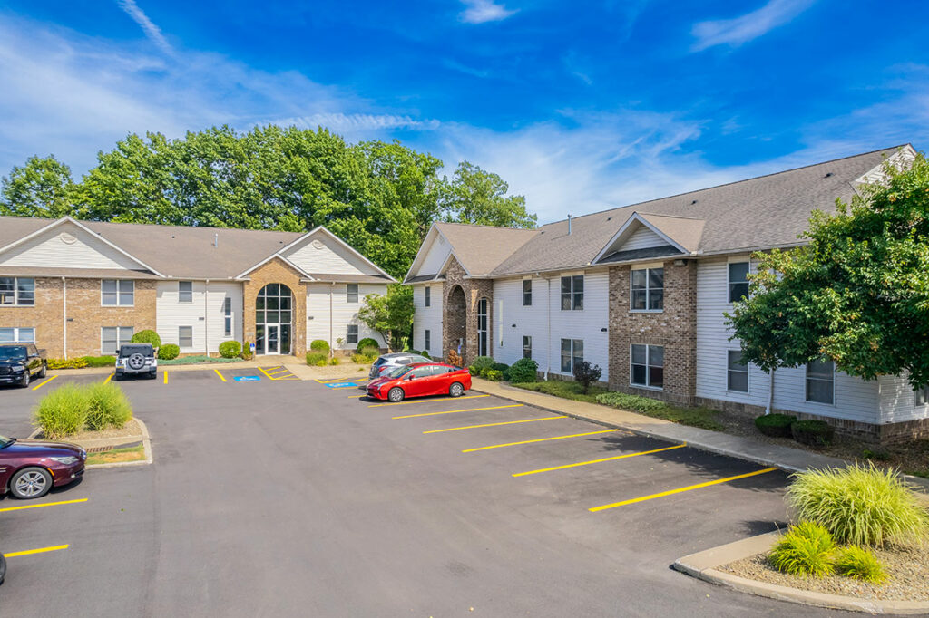 Exterior view of Laurel Ridge Building with grand cathedral-like brick entrances and spacious parking lot.