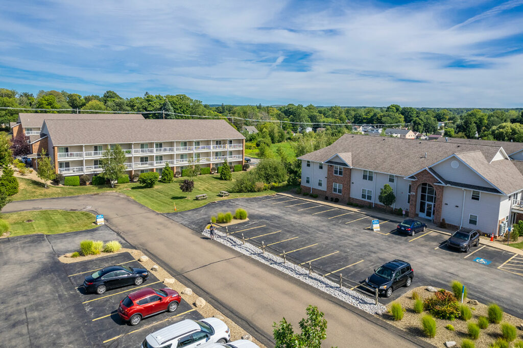 An aerial view of Laurel Springs Apartment, highlighting two distinct building types. One building offers patios and balconies, while the other does not include these features for all unit types.
