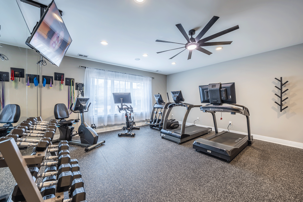 State-of-the-art fitness center equipped with treadmills, stationary bikes, free weights, and a variety of exercise machines for a comprehensive workout experience.